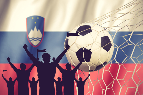 silhouettes of Soccer fans with flag of Slovenia .Cheer Concept  - Photo, Image