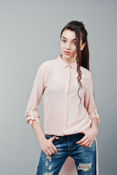 Portrait of young brunette girl wearing in pink blouse, ripped j - Fotoğraf, Görsel