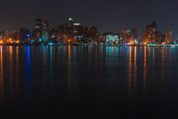 Blurred city and lake landscape at night. - Foto, afbeelding