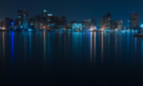 Blue city view from seaside  at night - blurred photo - Foto, Imagen