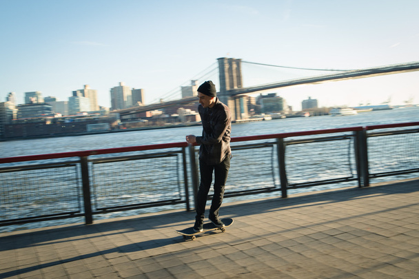 Young skateboarder cruise down on pedestrian walk - Foto, Imagen
