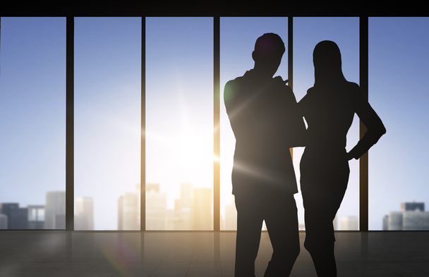 silhouettes of business partners over office - Foto, Imagem