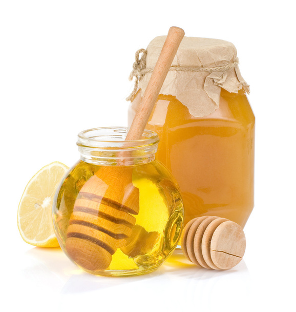 Glass jar full of honey and lemon - Valokuva, kuva