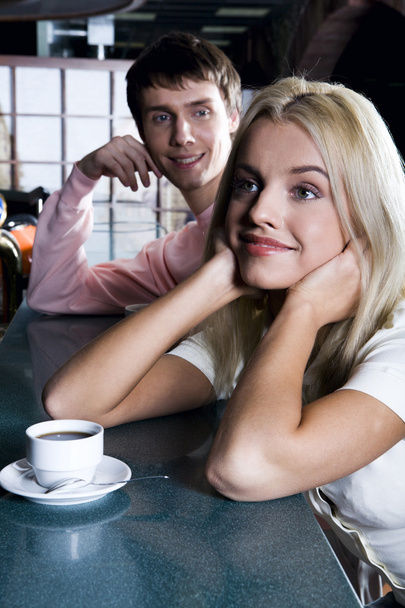 Smiling cute blond woman drinking coffee in the bar - Foto, Imagem