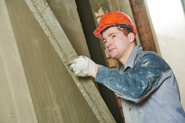 Plasterer at work with wall - Photo, Image