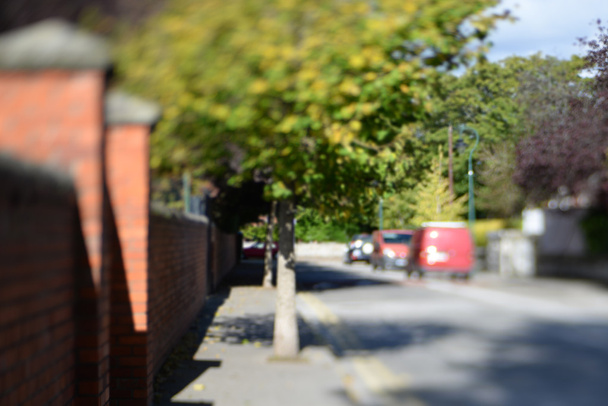 Blurred background. Cityscape bokeh. unfocused city street and green trees. out of focus background  - Photo, Image