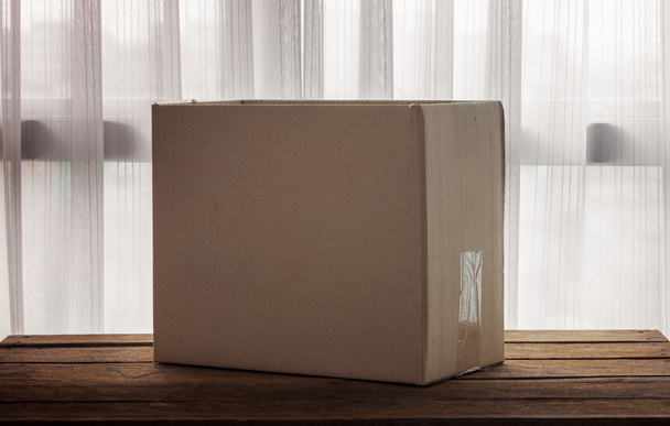 Cardboard box on wooden - Photo, Image