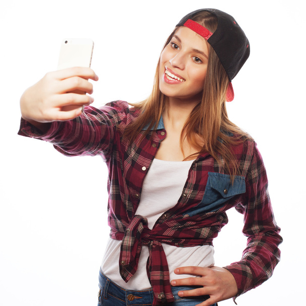 pretty teen girl wearing hat, taking selfies - 写真・画像