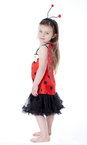 Young girl in ladybug costume on white - Foto, imagen