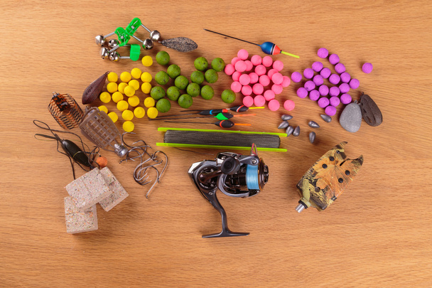 Fishing lure on a wooden table. Fishing tackle, baits, floats, feeders. - Photo, Image