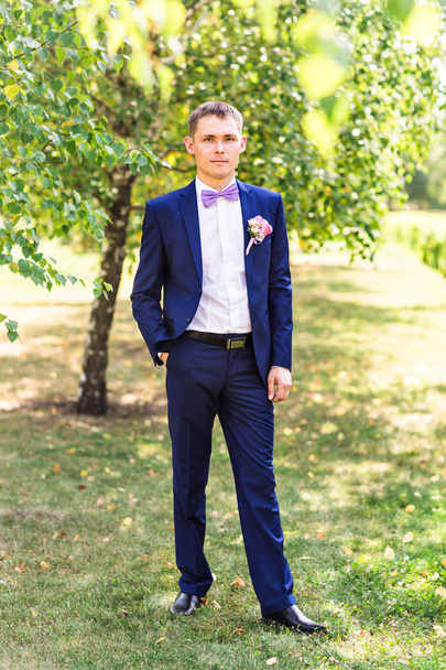 Sexy man in tuxedo and bow tie posing - Foto, Imagen