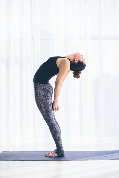 Beautiful yoga woman practice in a training hall background. Yoga concept. - 写真・画像