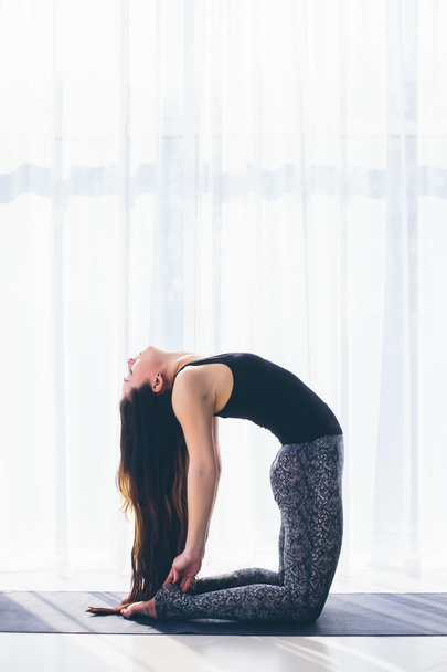 Beautiful yoga woman practice in a training hall background. Yoga concept. - Fotó, kép