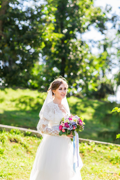 Wedding flowers ,Woman holding colorful bouquet with her hands on wedding day - Photo, Image