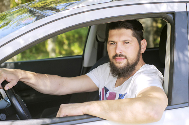 Handsome man driving a car. Stylish man. Bearded and handsome man - Photo, Image