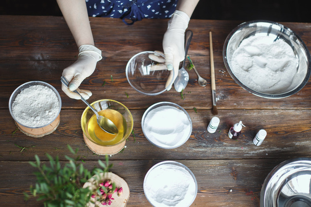 Preparation of bath bombs. Ingredients and floral decor on a wooden vintage table. - Photo, image