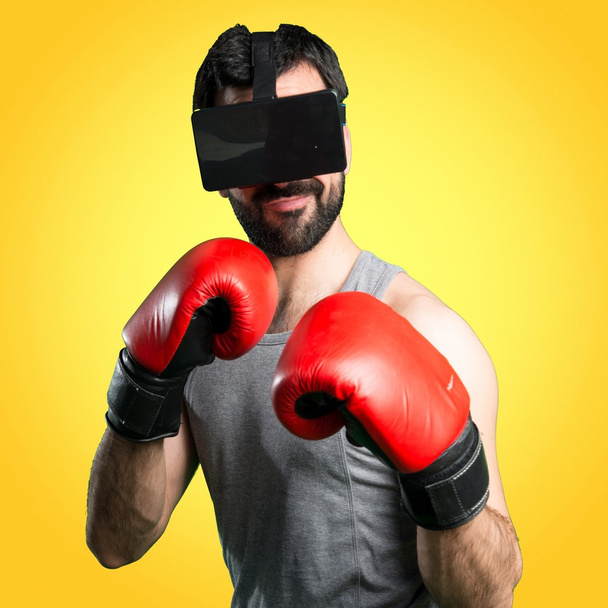 Sportman with boxing gloves and VR glasses - Foto, Imagen