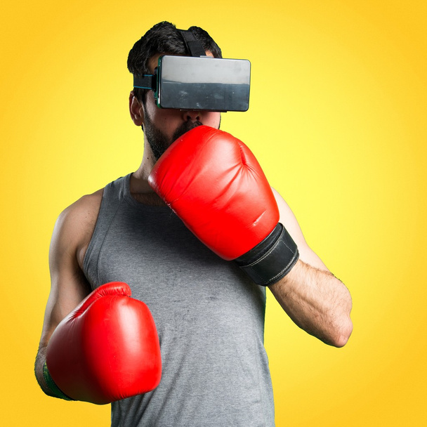 Sportman with boxing gloves and VR glasses - Fotó, kép