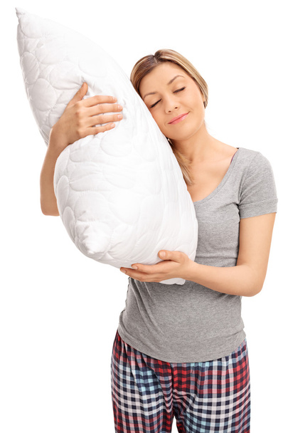 Blond woman hugging a pillow and sleeping  - Fotografie, Obrázek