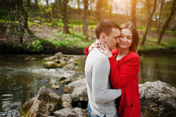 Cuddling couple stay at stones in river. Couple in love. Love co - Foto, Bild