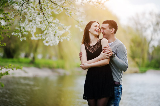 Young couple in love outdoor. Laugh and huggs background lake - Photo, Image