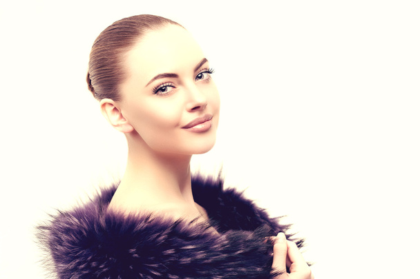 Woman in a fur coat. Young beautiful model in winter outerwear.  - Zdjęcie, obraz