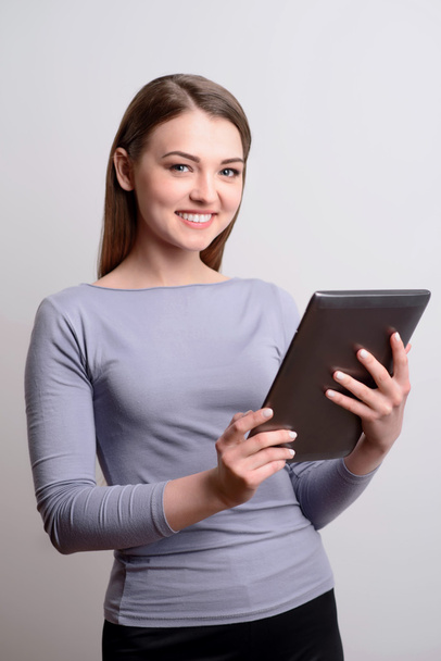 Delighted girl using tablet - Фото, изображение