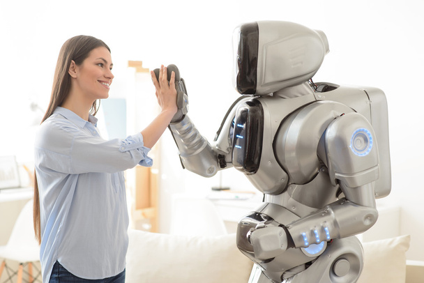 Positive  girl and robot giving high five - Foto, Bild