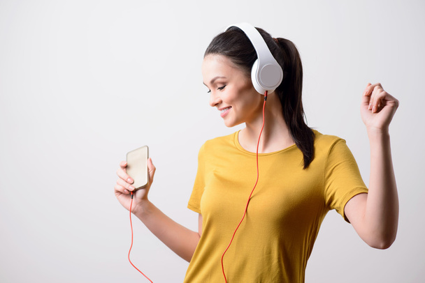 Positive girl listening to music - Фото, зображення