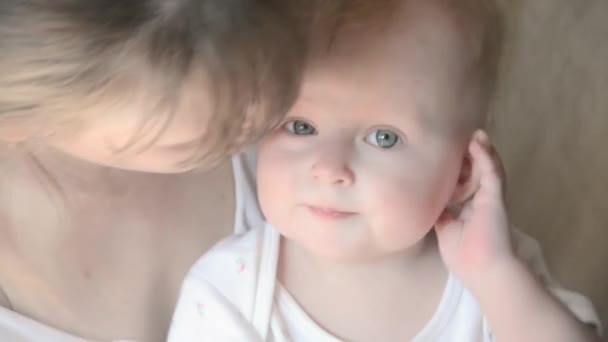 Closeup πορτρέτο του όμορφο απαλό μητέρα παίζοντας με χαριτωμένο μικρό μωρό στο κρεβάτι αγαπώντας νεαρή οικογένεια - Πλάνα, βίντεο