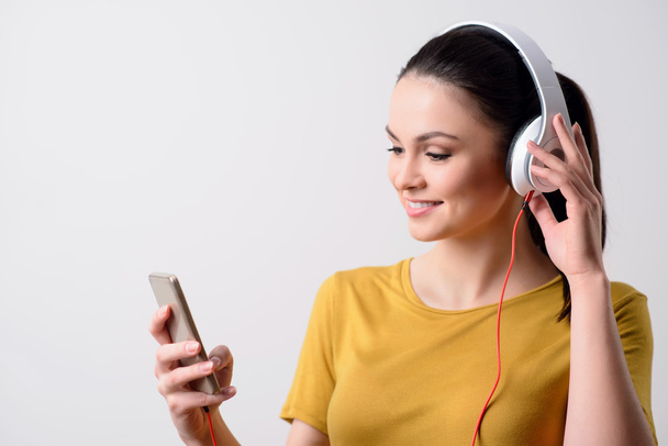 Delighted girl listening to music - Фото, изображение