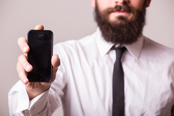 young bearded man pointet phone  - Photo, image