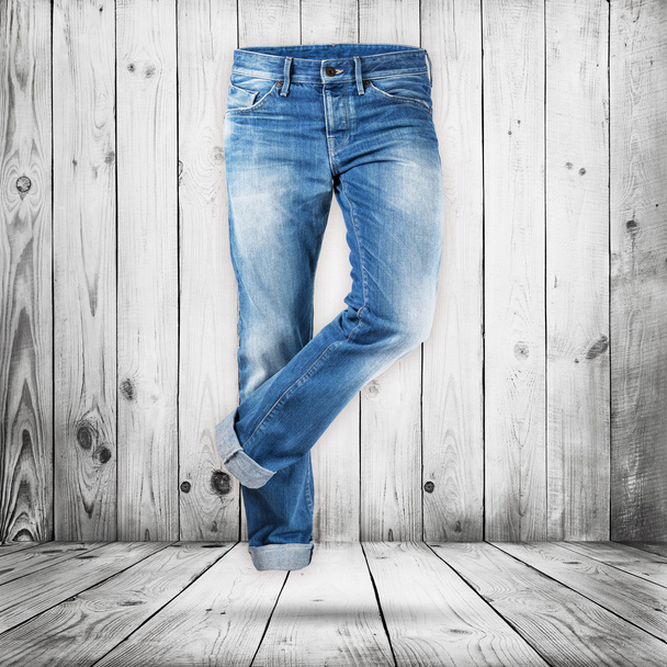 Jeans trouser over white wood planks background - Foto, Imagen