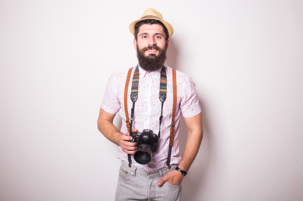 Young bearded treveler man with photocamera - 写真・画像