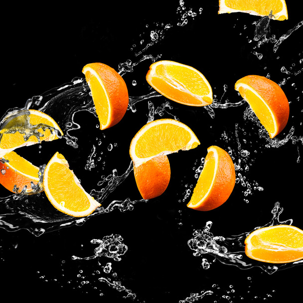 Orangene Früchte und spritzendes Wasser - Foto, Bild