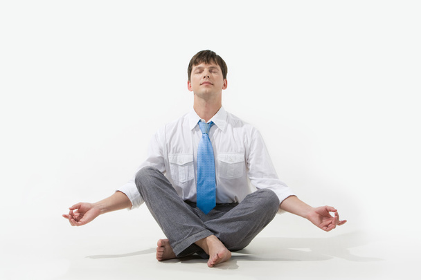 Photo of relaxed businessman meditating over white background - Fotografie, Obrázek