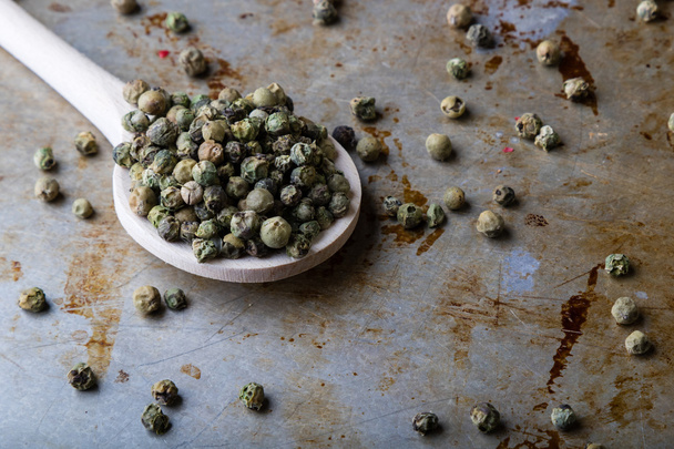 green peppercorn seeds on steel plate  - Photo, image