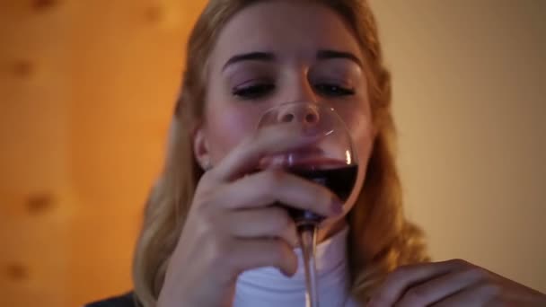 Lonely businesswoman sitting in office, drinking wine and thinking about life - Filmati, video
