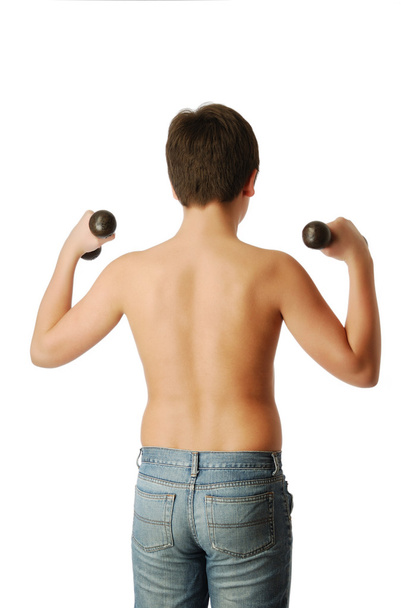 Teenage boy doing exercises with dumbbells. - Photo, Image
