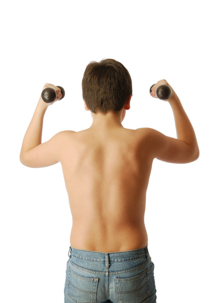 Teenage boy doing exercises with dumbbells. - Photo, Image