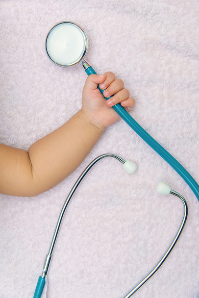 medical instruments stethoscope in hand of baby girl - Fotó, kép