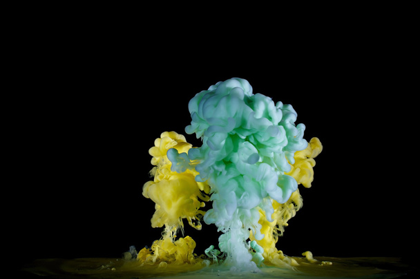 yellow and green liquid paint in water - Fotoğraf, Görsel