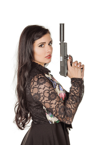 beautiful brunette woman with gun posing against white  - Fotoğraf, Görsel