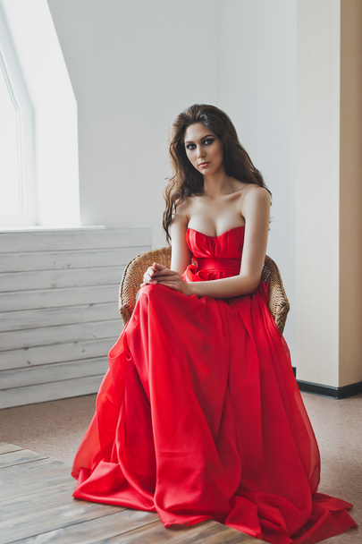 A girl in a red ball gown 5975. - Foto, Imagen