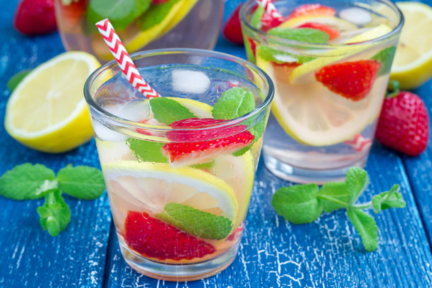 Strawberry mint homemade lemonade on blue wooden table - Фото, зображення