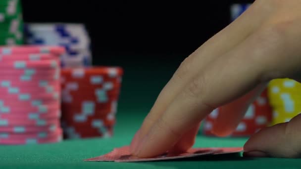 Poker player checking his cards on green casino table, slowmotion. Gambling - Filmati, video