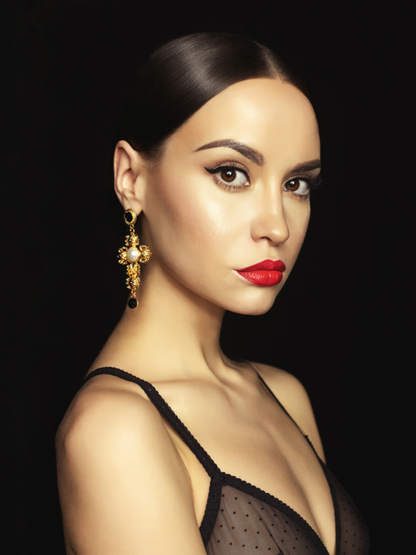 Beautiful lady with earring on black background - Fotó, kép