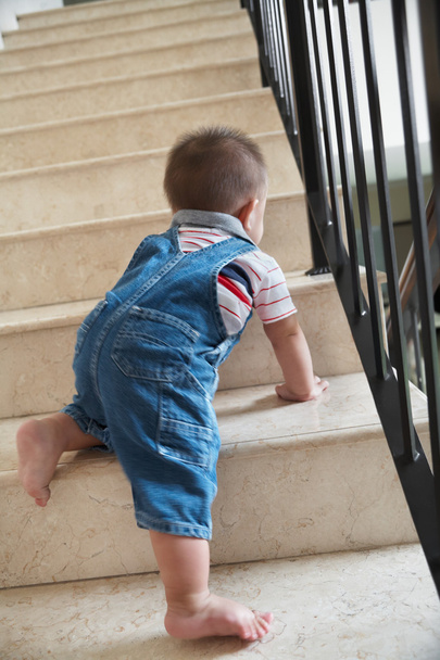 Baby crawling alon on stairs - Foto, Imagen