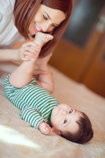 Portrait of happy mother and child playing - Photo, Image