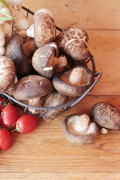 Mushrooms and vegetables on wood background. - Valokuva, kuva